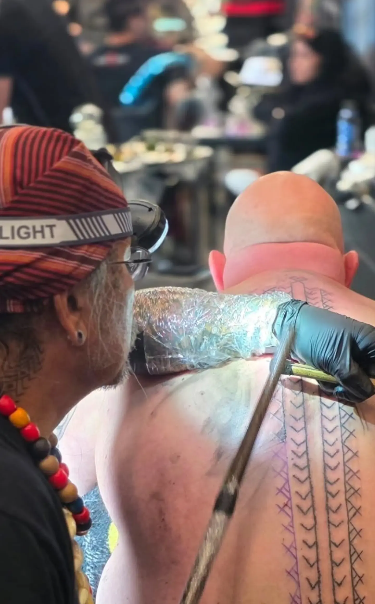 Tattoo artist tattooing at the Ancient Arts Festival.